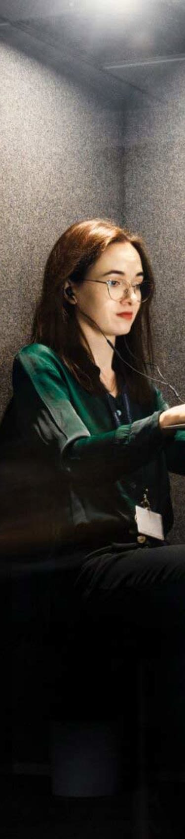 A woman working in the Gdańsk office in Poland, focused on her computer